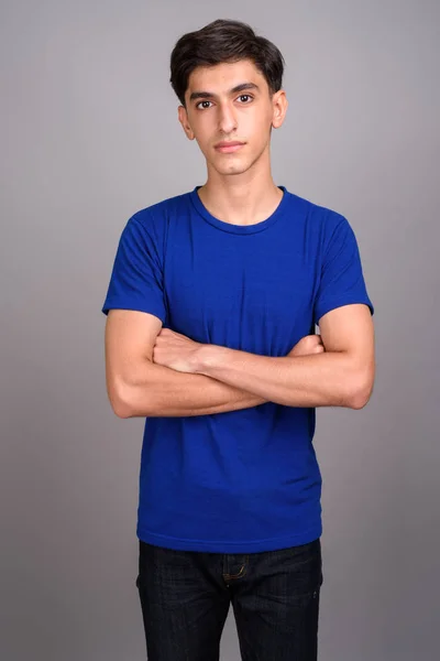 Young handsome Persian teenage boy with arms crossed — Stock Photo, Image
