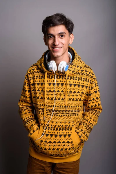 Joven guapo adolescente persa contra fondo gris —  Fotos de Stock