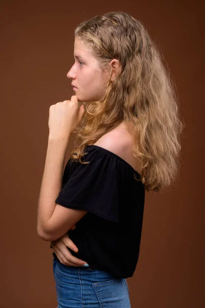 Profile view portrait of young beautiful blonde teenage girl thinking — Stock Photo, Image