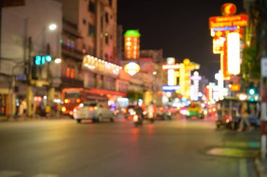 Blurred view of the night street in Chinatown with illuminated red lights at Bangkok clipart