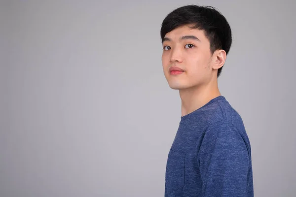 Head shot profile view of young Asian man looking at camera — Stock Photo, Image