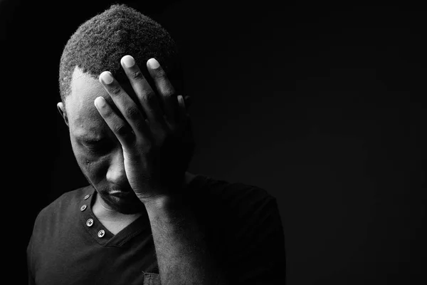 Sad young African man looking stressed in black and white — Stock Photo, Image