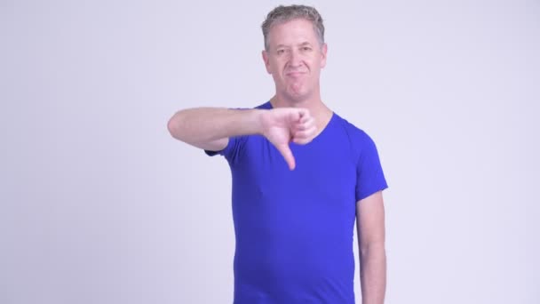 Serious mature man giving thumbs down and showing stop gestures — Stock Video