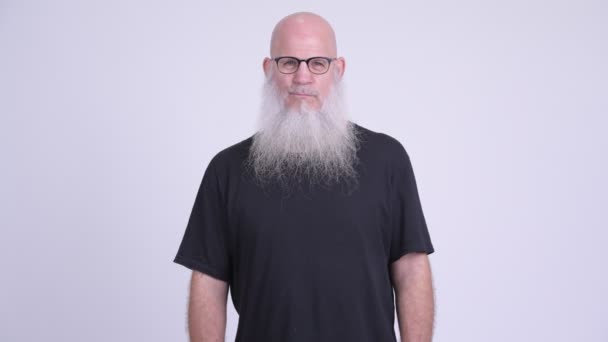 Mature bald bearded man wearing eyeglasses with arms crossed — Stock Video