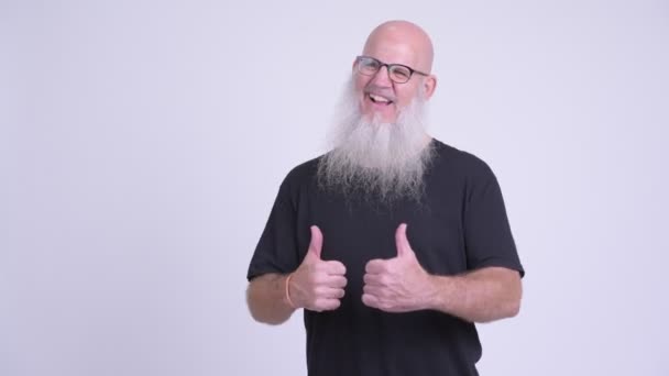 Happy mature bald bearded man looking excited while giving thumbs up — Stock Video