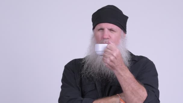 Face of mature bearded hipster man relaxing while drinking coffee — Stock Video