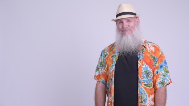 Happy mature bearded tourist man smiling and showing something — Stock Video