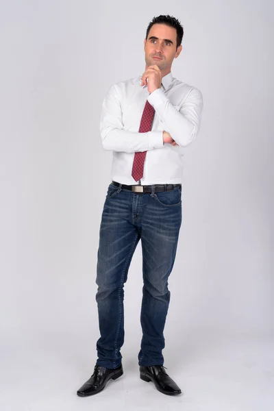 Full body shot of handsome businessman thinking against white background — Stock Photo, Image
