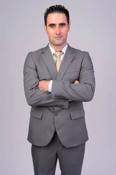 Jóképű üzletember visel öltönyt, fehér háttér — Stock Fotó