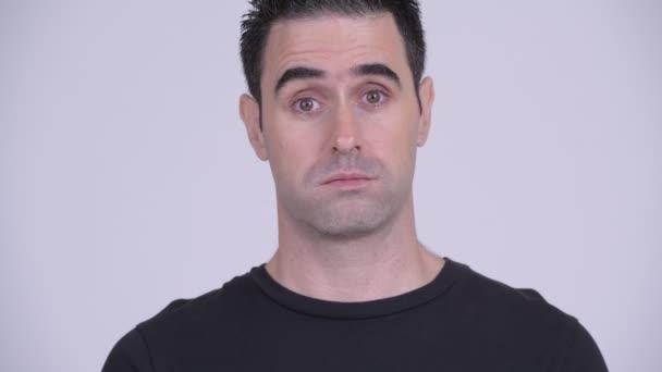 Face of stressed man looking frustrated and bored against white background — Stock Video