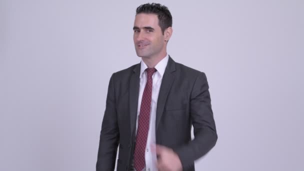 Счастливый красивый бизнесмен, показывающий большие пальцы на белом фоне — стоковое видео