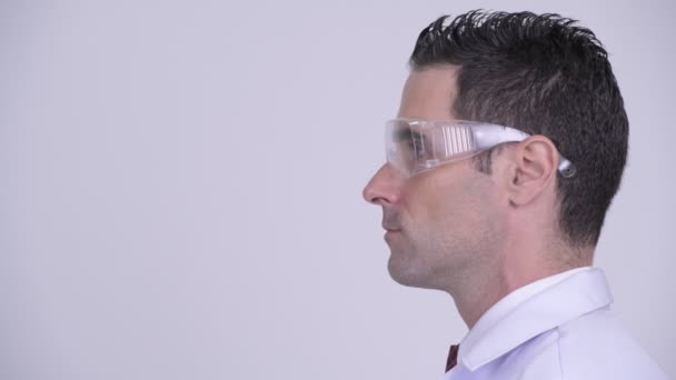 Head shot profile view of happy man doctor wearing protective glasses smiling — Stock Video