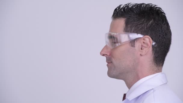 Head shot profile view of handsome man doctor wearing protective glasses thinking — Stock Video