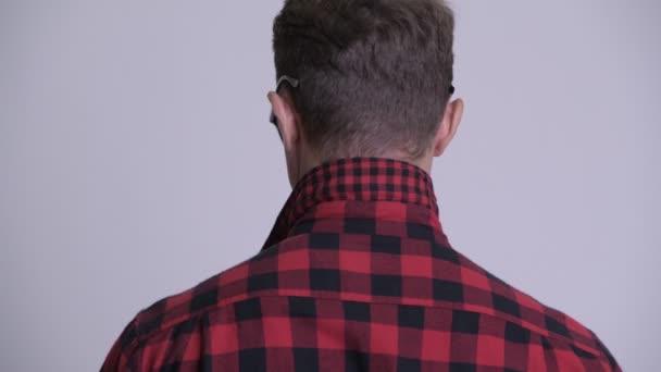 Face of handsome bearded hipster man looking back and removing sunglasses — Stock Video