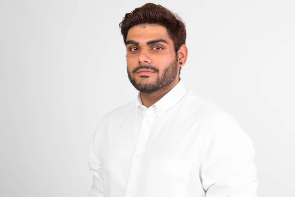 Young handsome bearded Indian man against white background — Stock Photo, Image