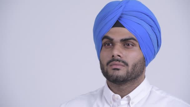 Face of young bearded Indian Sikh man with turban thinking — Stock Video