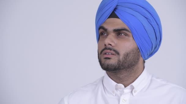 Face of young bearded Indian Sikh man thinking — Stock Video