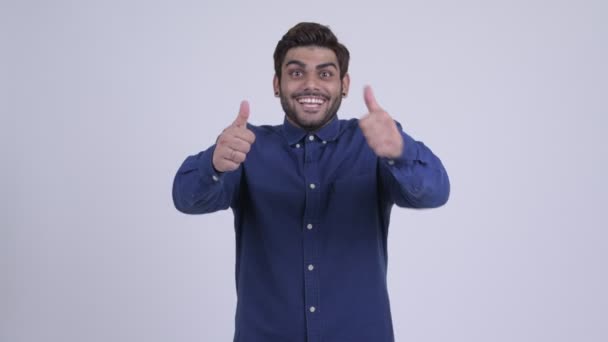 Happy young bearded Indian businessman looking excited while giving thumbs up — Stock Video