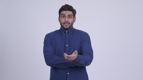 Joven empresario indio barbudo explicando algo — Vídeo de stock