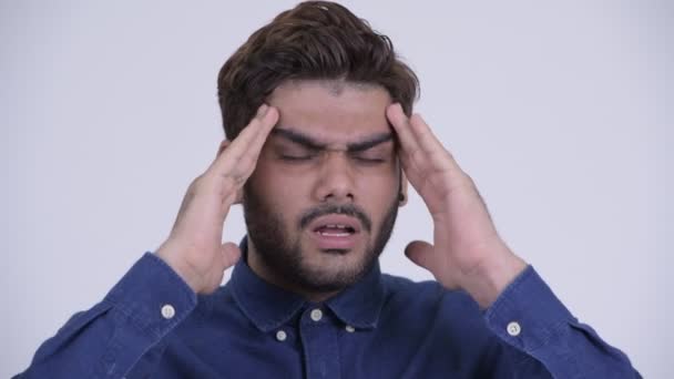 Stressed young bearded Indian businessman having headache — Stock Video