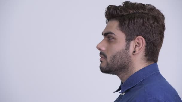 Closeup profile view of young bearded Indian businessman looking at camera — Stock Video