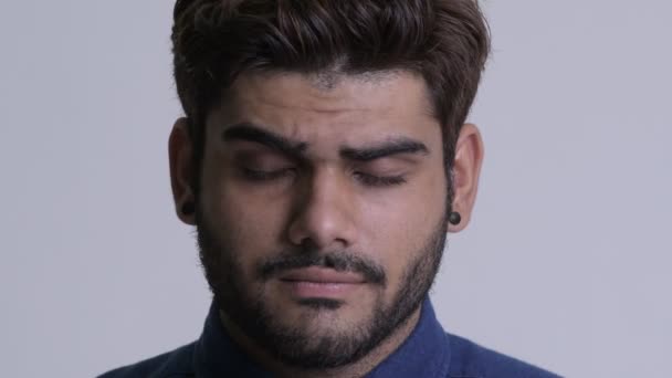 Face of young bearded Indian businessman looking sad and depressed — Stock Video