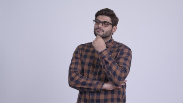 Boldog fiatal szakállas indiai csípő ember mosolyogva és a gondolkodás — Stock videók