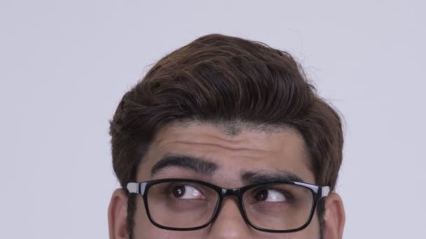 Eyes of young Indian hipster man with eyeglasses thinking — Stock Video