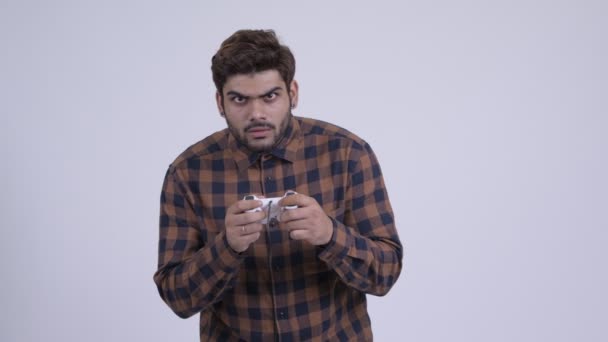 Stressed young bearded Indian hipster man playing games and losing — Stock Video