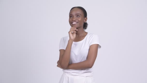 Young happy African woman thinking and looking up — Stock Video