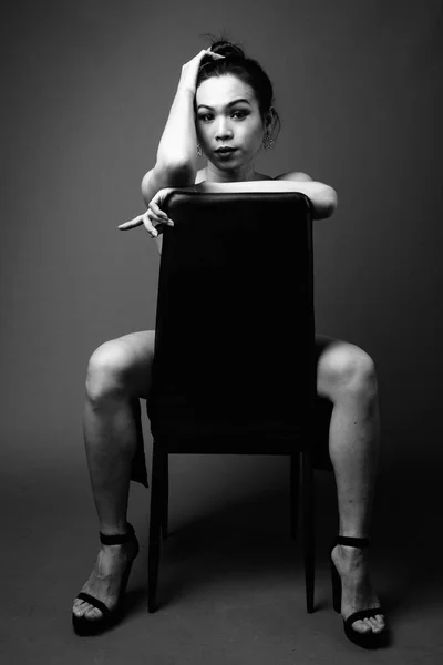Young beautiful Asian transgender woman in black and white