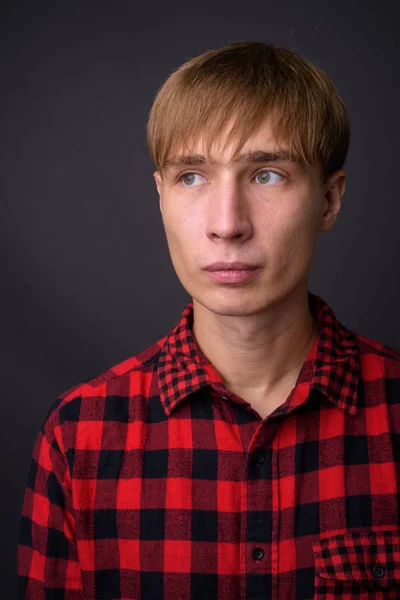 Face of young handsome man with blond hair thinking — Stock Photo, Image