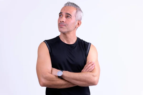 Handsome Persian man thinking with arms crossed ready for gym — Stock Photo, Image