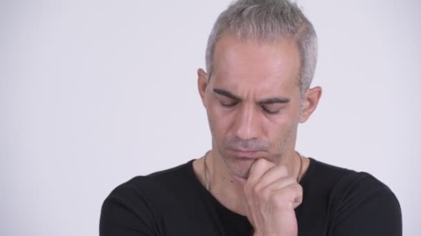 Serious Persian man thinking against white background — Stock Video