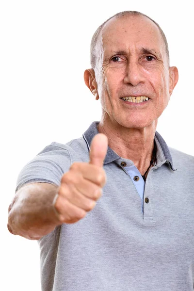 Studioaufnahme eines glücklichen Seniors, der lächelt und den Daumen hebt — Stockfoto