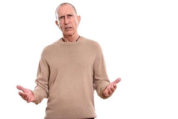 Studio shot of angry senior man looking confused — Stock Photo, Image