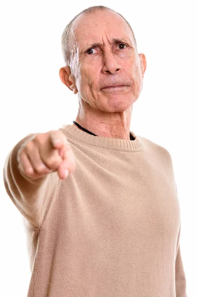 Studio shot of angry senior man pointing finger at camera — Stock Photo, Image