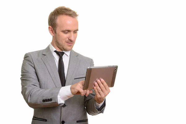 Handsome Caucasian businessman using digital tablet isolated against white background — Stock Photo, Image