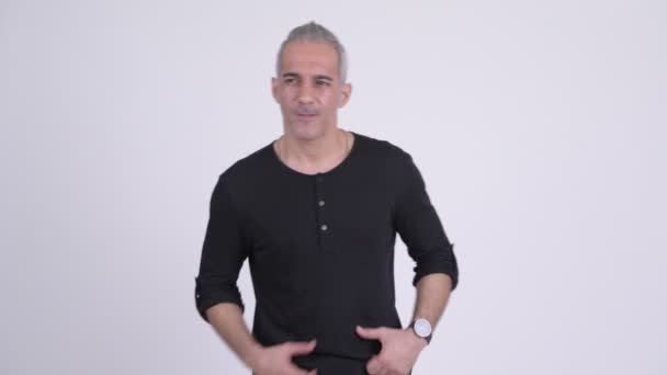 Stressed Persian man having stomach ache against white background — Stock Video