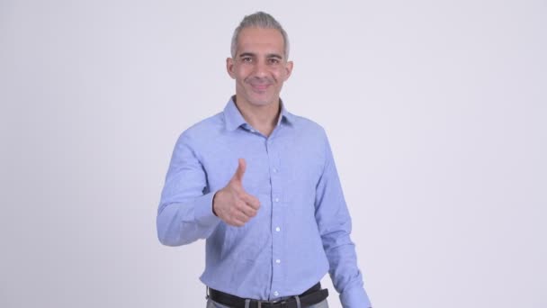 Happy Persian businessman giving thumbs up against white background — Stock Video