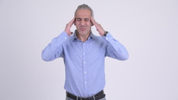 Stressed Persian businessman having headache against white background — Stock Video