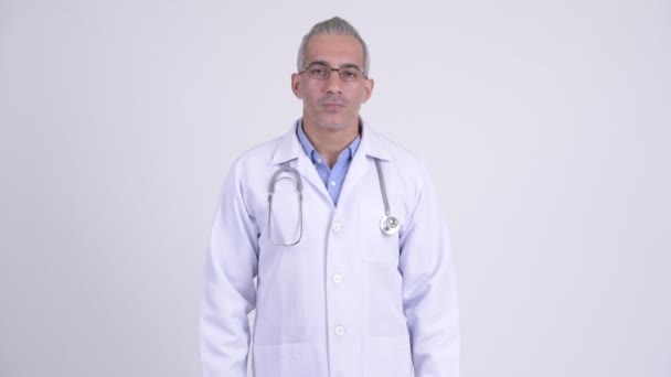 Confused Persian man doctor shrugging shoulders — Stock Video