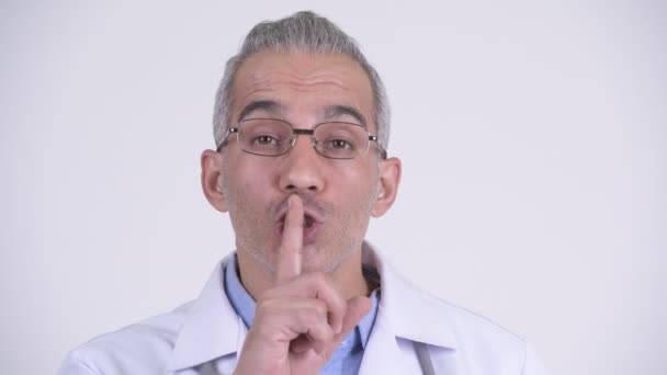 Guapo persa hombre médico con el dedo en los labios sobre fondo blanco — Vídeo de stock