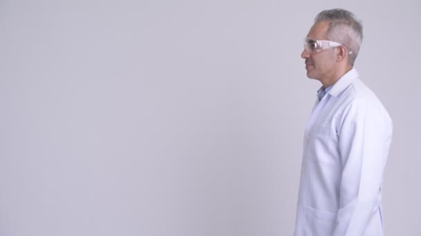 Profile view of Persian man doctor wearing protective glasses — Stock Video