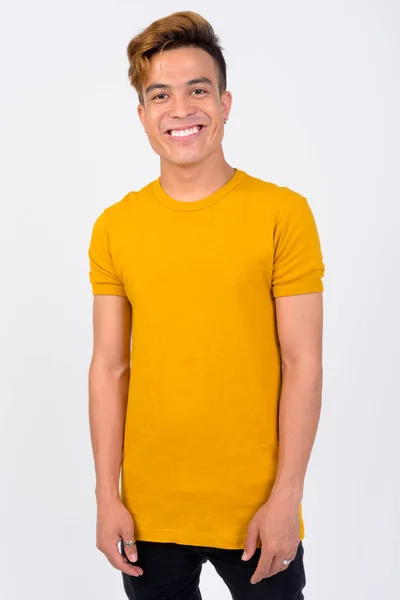 Portrait of young Asian man against white background — Stok Foto