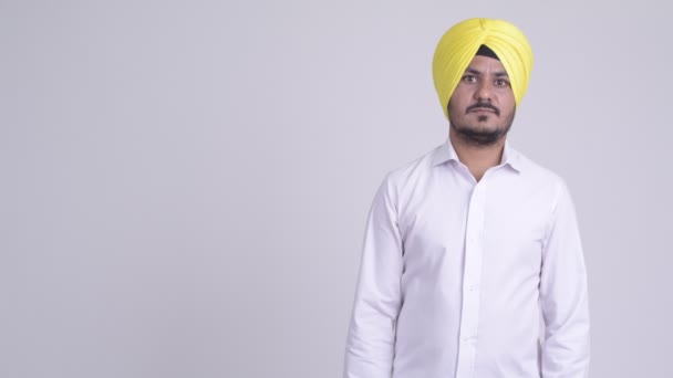 Happy vousatých indická Sikh podnikatel prsty a ukazovat něco — Stock video