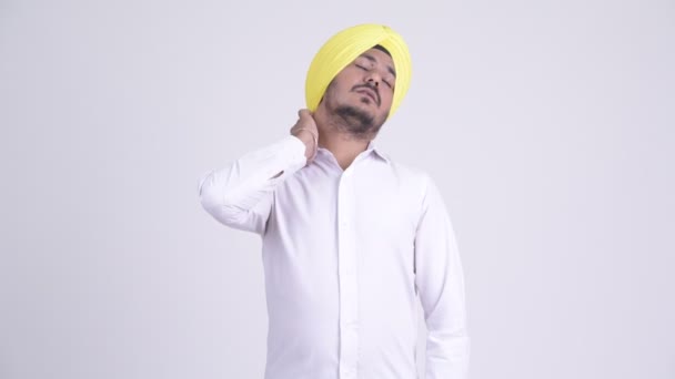 Stressed bearded Indian Sikh businessman having neck pain — Stock Video