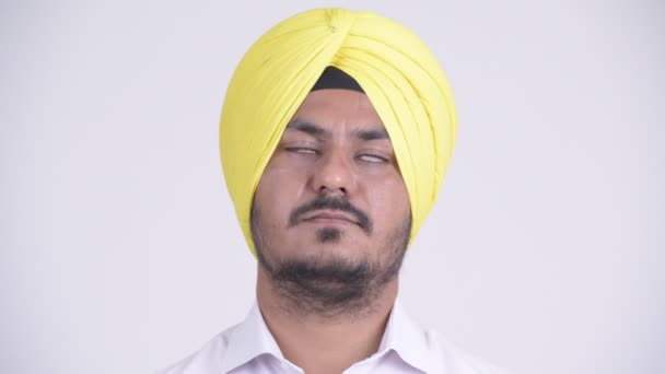 Face of happy bearded Indian Sikh businessman relaxing with eyes closed — Stock Video