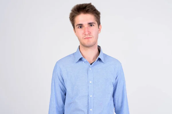 Young handsome businessman looking at camera against white background — Stock Photo, Image