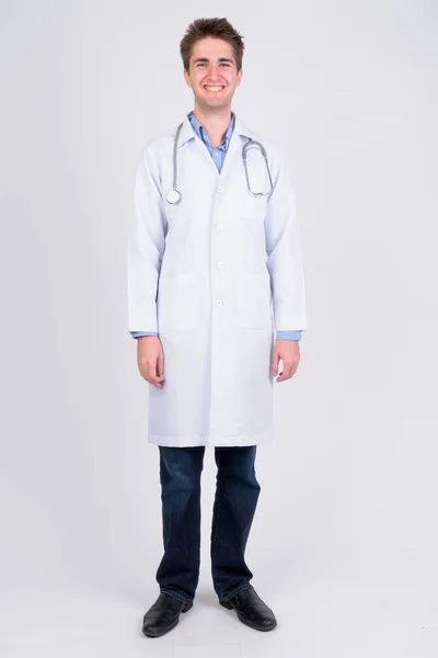 Full body shot of young happy man doctor smiling — Stock Photo, Image